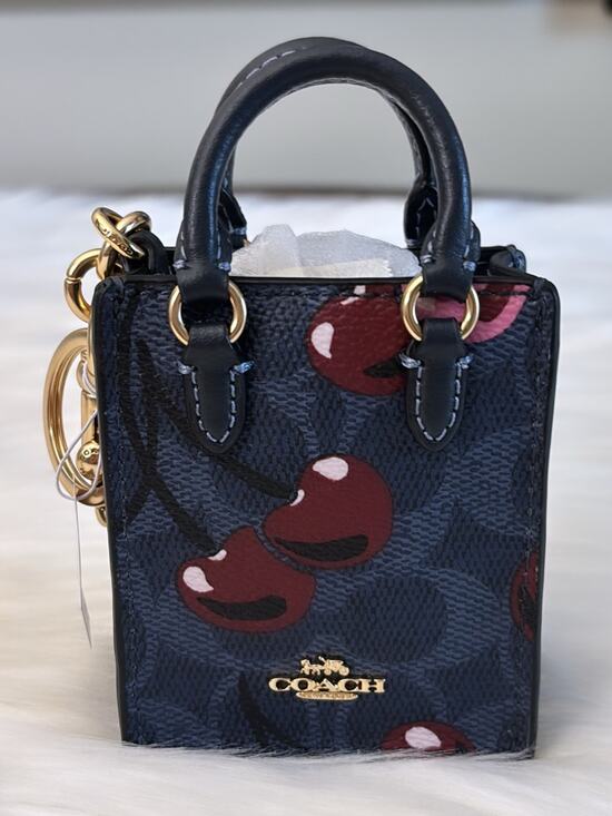 Coach Handbags - COACH North/South Mini Tote Bag Charm In Signature Canvas With Cherry Print